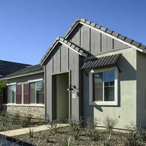 the front of a house with a driveway and a sidewalk