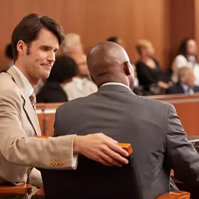 Graham Scofield speaking with client in courtroom