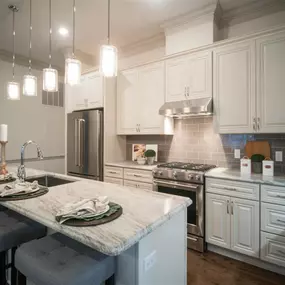 A sleek dining area at Tindall Park at SouthPark Apartments with modern appliances and stylish decor.