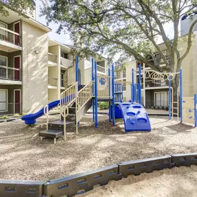 An outdoor children's playground at Magnolia Terrace Apartments in Houston with durable play equipment.