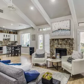 A spacious common room at Magnolia Terrace Apartments in Houston with a cozy fireplace and a coffee area.