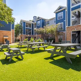 A relaxing outdoor sitting area at Gramercy Park Apartments in Houston with comfortable seating and a scenic setting.