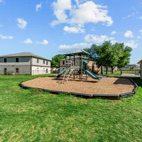 An outdoor playground at Huntington Meadows Apartments in Austin with sturdy play structures.