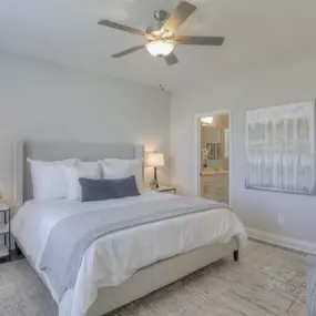 Beautiful bedroom with ceiling fan, ensuite bathroom, and large walk-in closet.