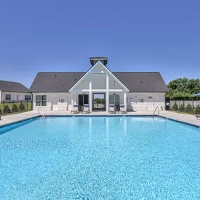 Large pool with covered deck and ample seating.