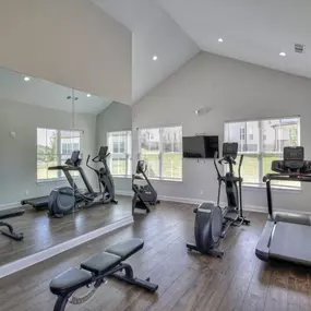 Fitness center with cardio machines and free weights.