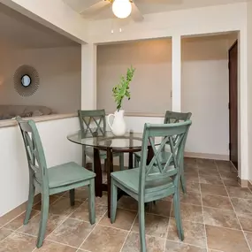 A dining room with a table and chairs