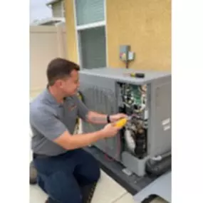 An Aced It! Cooling & Heating technician servicing an outdoor air conditioning unit at a residential property in Corona, CA. The technician is shown using advanced tools, demonstrating the company’s commitment to reliable and professional HVAC repair and maintenance. Highlighting local expertise, this photo emphasizes the trusted services provided to homeowners in the area.