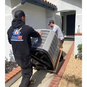 Two Aced It! Cooling & Heating technicians delivering and installing a new HVAC unit at a residential property in Corona, CA. The technicians are shown working professionally, ensuring high-quality service for a homeowner. This image showcases the company's expertise in HVAC installation and replacement services, emphasizing reliability and local trust.