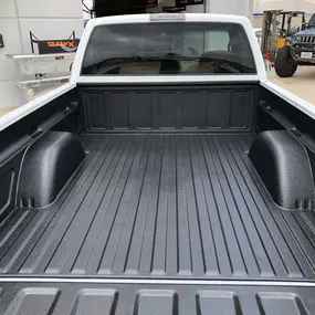 Line-X spray-in bedliner application for truck owners in Plano TX, ensuring maximum durability and bed protection.