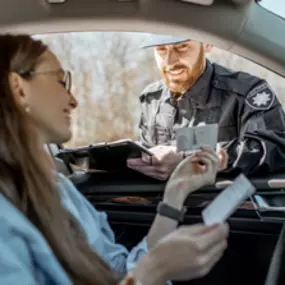 a woman showing a police officer her SR-22 insurance card