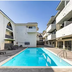 swimming pool with new outdoor patio furniture and lounges