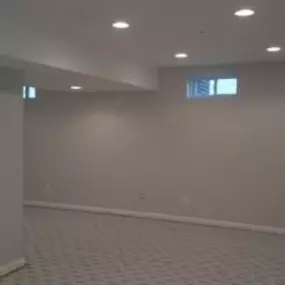 This fully finished basement has new walls, ceiling, recessed lighting, and carpet.