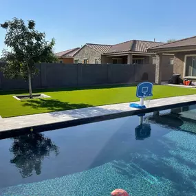 Upgrade your backyard with luxury poolside hardscaping, featuring custom pavers and landscaping elements that create a resort-style oasis.