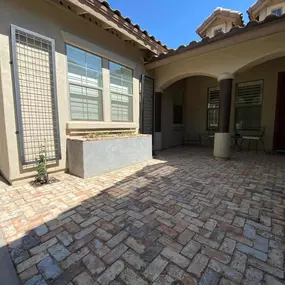 Create the perfect outdoor living area with a custom-designed paver patio and shaded seating area, blending functionality with elegance.