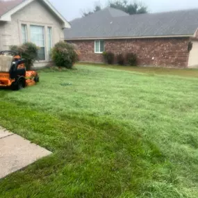 Residential Mowing Property During a Rainy Day