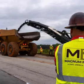 back of magnum paving employee and a cold planer