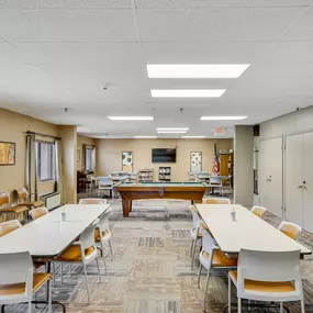 A conference room with a long table and chairs