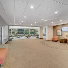 A spacious waiting area with orange and beige furniture