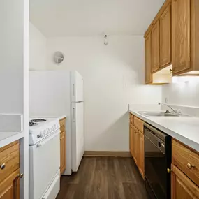 A kitchen with wooden cabinets and white appliances