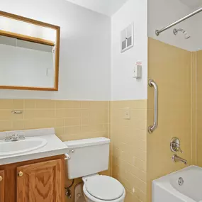 A bathroom with a toilet, sink, and bathtub