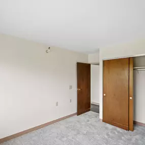 A room with a carpeted floor and a white ceiling