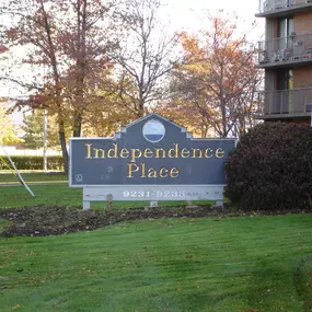 A sign for Independence Place stands in a grassy area