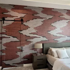 Talk about making a statement, this stunning feature wall transforms the entire bedroom with its rich texture and bold pattern. The Wallpaper Co. delivers another flawless wallpaper installation, perfectly aligned even around the sliding barn door for a sleek, cohesive finish. It is a beautiful reminder of how great design and quality execution can completely transform a space.