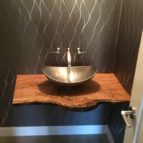 The Wallpaper Co – Scottsdale brings sophistication to this powder room with a sleek metallic wave wallcovering that catches the light beautifully. As trusted wallpaper installers and designer wallpaper experts, they create bold, modern spaces that pair texture and shine for an unforgettable finish.