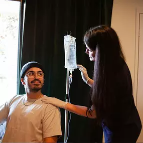 Man receiving IV therapy at home in Los Angeles from a mobile IV nurse