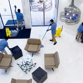 TamCare Services team cleaning and organizing an office lobby to create a welcoming and professional environment. Trusted janitorial solutions for high-traffic areas.