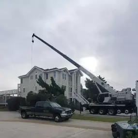 Residential crane lift in the Outer Banks — safe, efficient, and professionally handled.