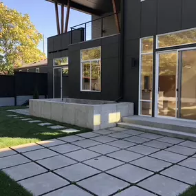 Large backyard paver patio and matching walkway.