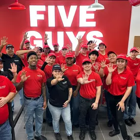 Crew members pose for a photograph inside the dining room ahead of the grand opening of the Five Guys restaurant at 12016 Alamo Ranch Parkway in San Antonio, Texas.