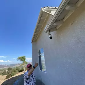 A satisfied customer in Fallbrook, CA, reviewing their newly installed AI-powered security camera system by NextGen Technology Solutions. With a thumbs-up, they confirm the seamless installation and advanced features, including remote monitoring, motion detection, and 24/7 surveillance for ultimate peace of mind.