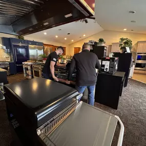 A behind-the-scenes look at appliance setup in the Voss live showroom, featuring luxury brands and custom ventilation.