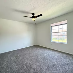 Empty bedroom room with a ceiling fan