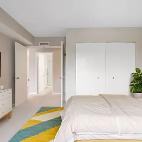 A furnished guest bedroom with a large closet