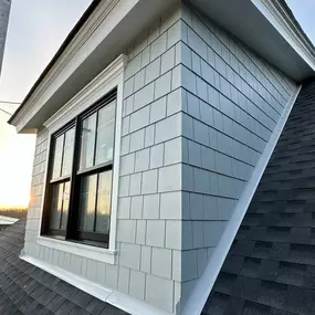 Dormer with cedar shake siding.