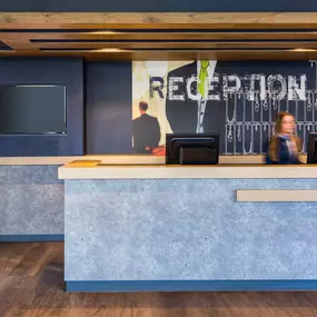 The reception area at Ibis Budget Amsterdam South showcases a friendly front office employee ready to assist guests. With a simple and welcoming design, the reception provides an efficient and professional check-in experience, reflecting the hotel’s commitment to affordable comfort and guest satisfaction.