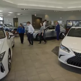 Lexus of Peoria dealership showroom with team members walking around