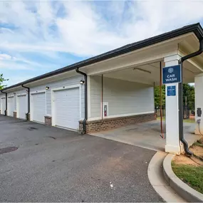 A car wash station with a blue sign above it