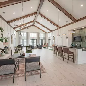 A large open living room with a kitchen area in the background