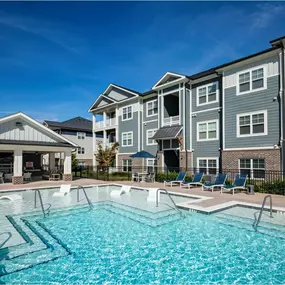 A swimming pool in front of apartment buildings