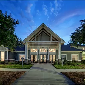 A modern building with a large front entrance and a pathway leading to it