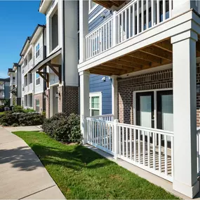 A row of apartment buildings with white railings and balconies