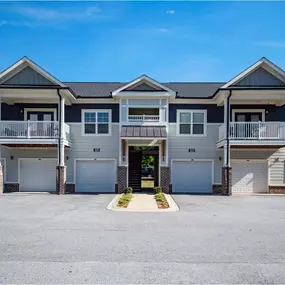 A row of houses with garages and driveways