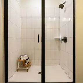 Glass-enclosed shower with modern tile surround at Camden West Nashville apartments in Nashville, TN