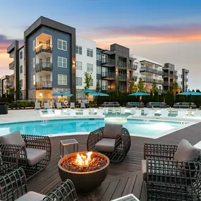 Firepit and seating on the deck in the middle of the pool at twilight at Camden West Nashville apartments in Nashville, TN