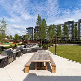 Outdoor kitchen next to the event lawn and volleyball court at Camden West Nashville apartments in Nashville, TN